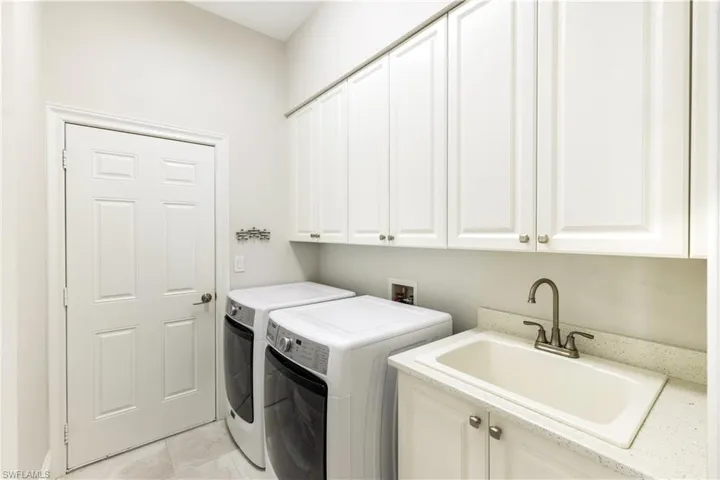 Very workable Laundry Rm w/sink and cabinet storage-door is to attached two car garage
