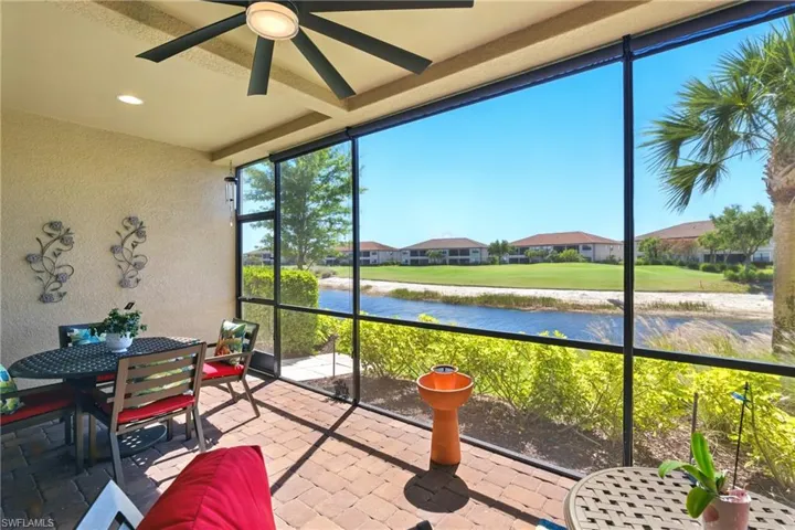 Sunroom featuring a water view, ceiling fan, outdoor dining area, and a healthy amount of sunlight