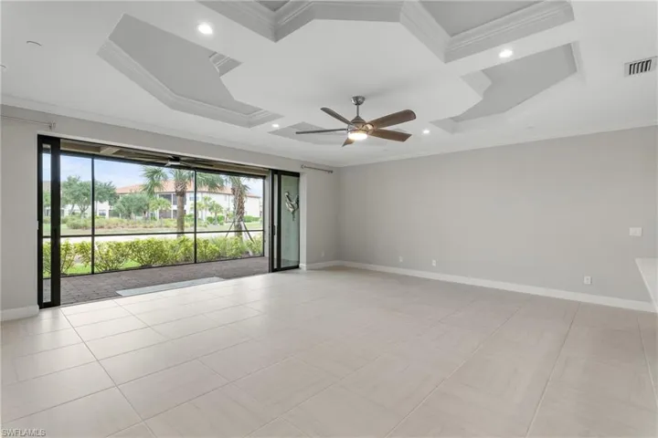 Unfurnished room featuring baseboards, a ceiling fan, crown molding, coffered ceiling, and recessed lighting