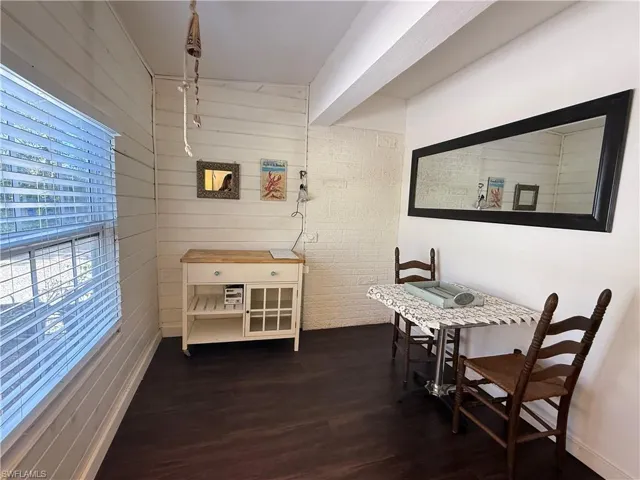 Inlaw Suite Dining area with wood walls and dark wood finished floors