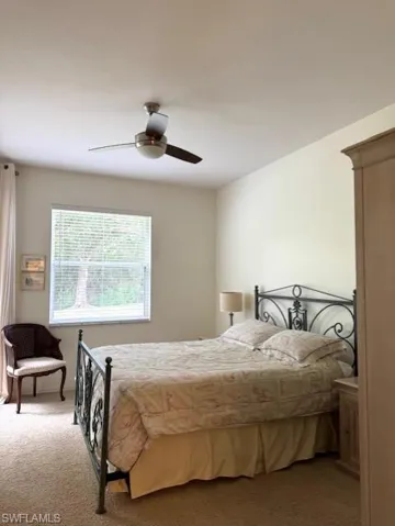Carpeted bedroom with ceiling fan