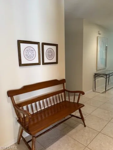 Stairway featuring baseboards and tile patterned floors