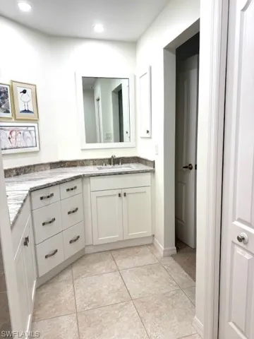 Bathroom with vanity and light tile patterned floors