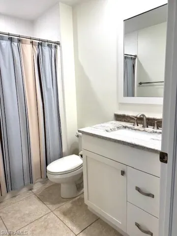 Bedroom featuring access to exterior, dark colored carpet, and ceiling fan