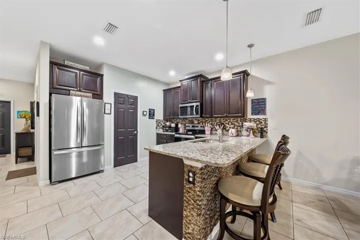 Spacious kitchen with newer stainless steel appliances.