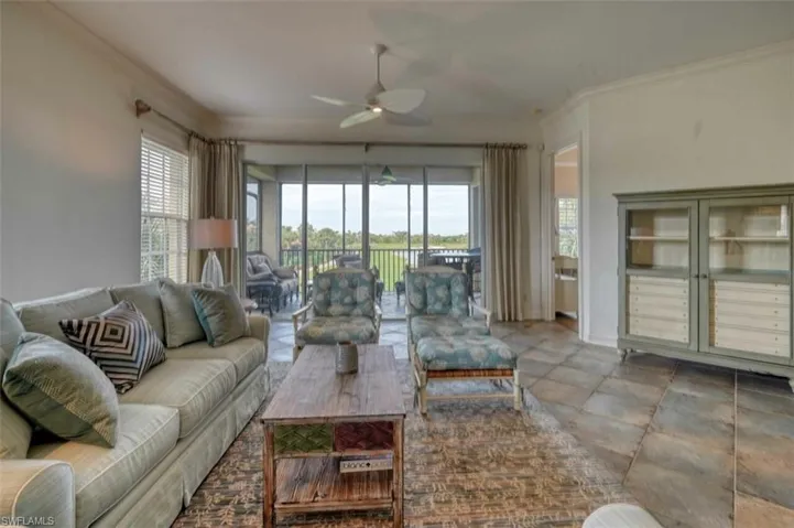 Living room with ceiling fan and crown molding
