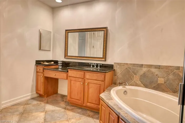 Bathroom with a bath and vanity