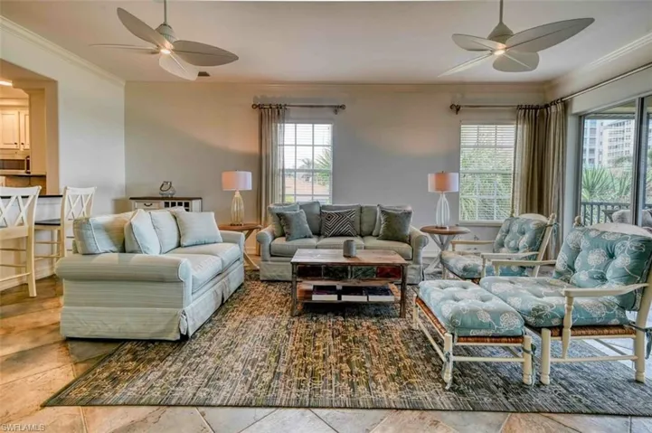Living room with ceiling fan and ornamental molding