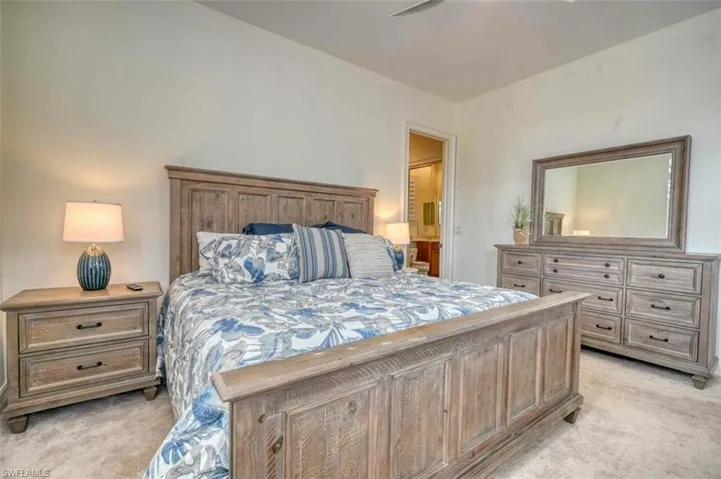 Carpeted bedroom featuring connected bathroom