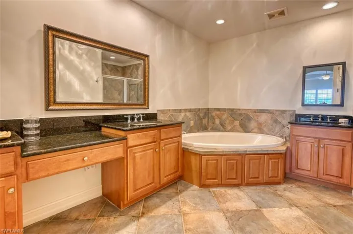 Bathroom with vanity and plus walk in shower