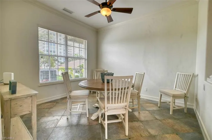 Dining room featuring ceiling fan and ornamental molding