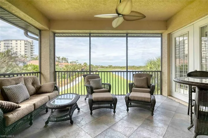 Sunroom featuring ceiling fan and a wealth of natural light