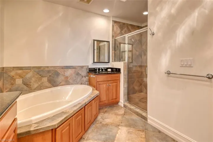 Bathroom with vanity and separate shower and tub