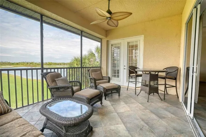 Sunroom featuring ceiling fan, a wealth of natural light, a water view, and french doors