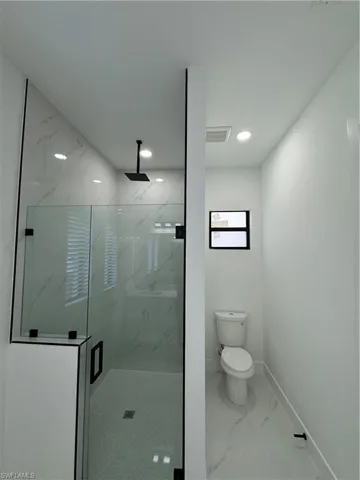 Bathroom with an enclosed shower and toilet