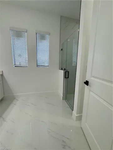 Bathroom featuring vanity and a shower with shower door