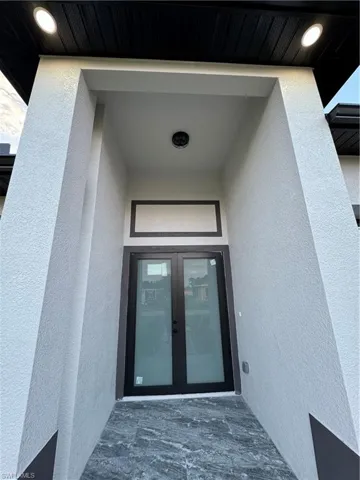 View of exterior entry featuring french doors
