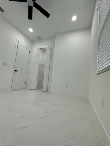Unfurnished bedroom with ceiling fan