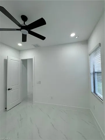 Unfurnished room featuring ceiling fan