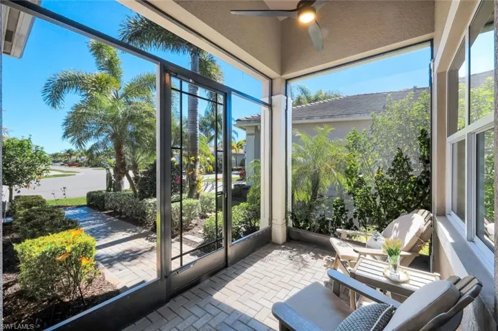 A welcoming front porch, screened-in for practicality and year round enjoyment