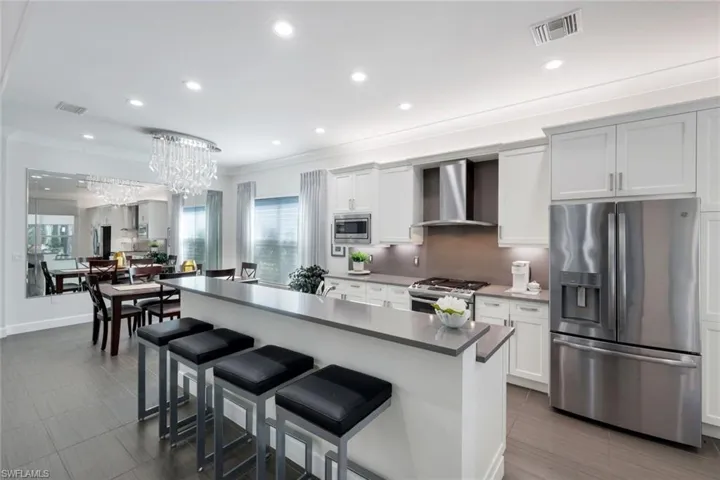 Light and bright this home is ready to entertain! The details matter: Notice the recessed lighting, Coordinated counter and backsplash, designer chandelier, gas range for all of those chefs, Lovely clean shaker cabinetry with molding finish and the list goes on!