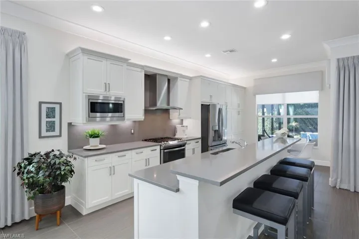 Upper and Lower cabinetry accent lighting, sleek pulls, soft close doors, slide out trash and recycle, Built-in Microwave, Lovely Custom Hood that vents to exterior of home, Lovely Pull Out Cabinetry to the right of the French Door refrigerator perfect for additional storage and pantry items!