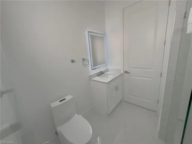 Bathroom with vanity and light marble finish floors