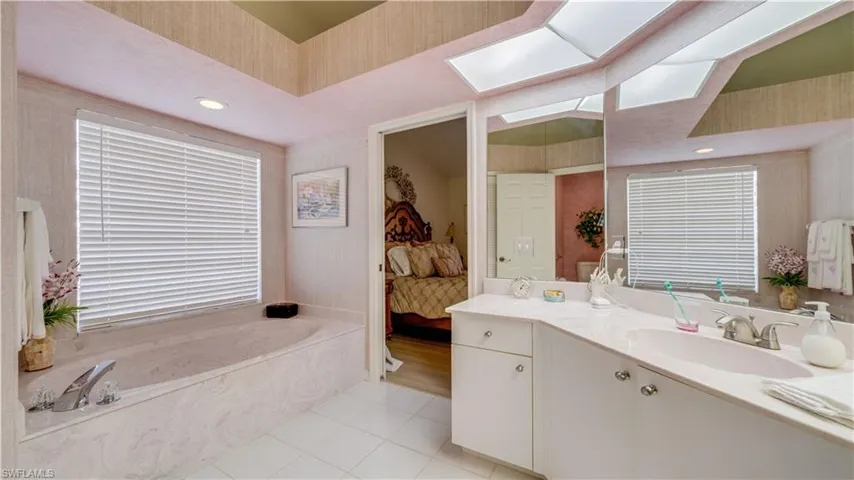 Primary bathroom with vanity and soaker tub