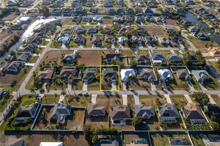 Aerial perspective of suburban area featuring property boundaries highlighted