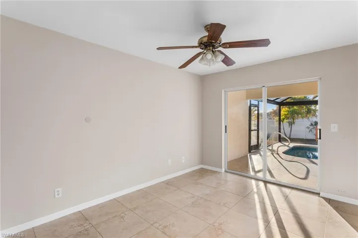 Spare room featuring a ceiling fan and light tile patterned floors