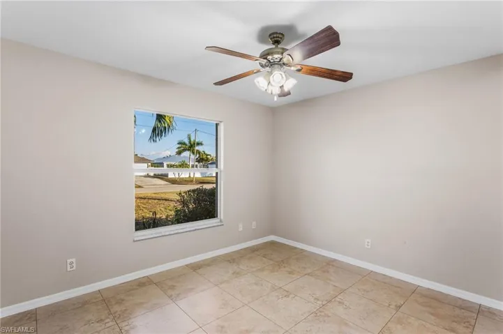 Spare room featuring baseboards and a ceiling fan