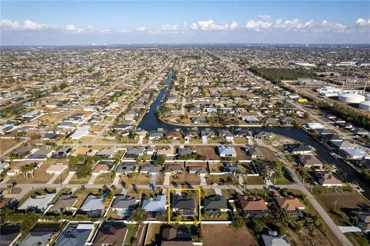 Aerial perspective of suburban area with a nearby body of water