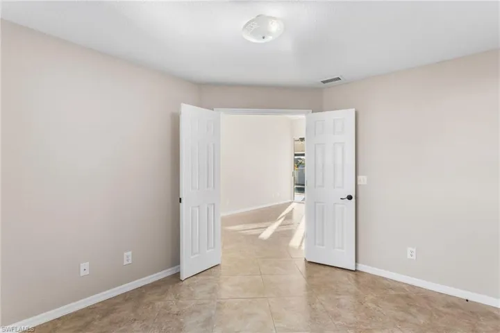 Unfurnished room featuring baseboards and light tile patterned floors