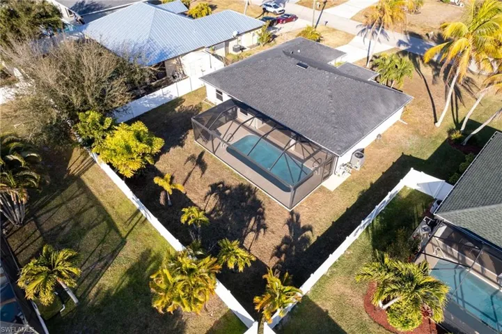 Aerial view of property and surrounding area featuring a pool