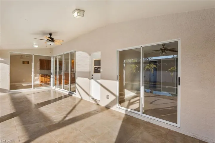 Under Truss Lanai 293 square feet of outdoor living sunroom with ceiling fan.