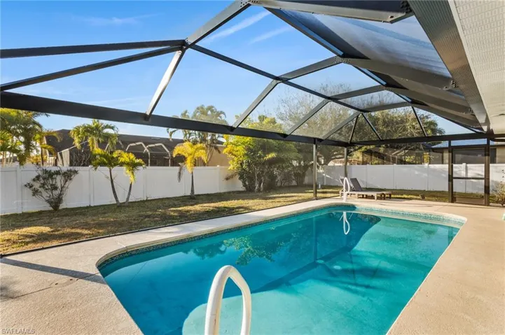 View of pool featuring a fenced backyard, a lanai, a sunroom, and picture window screen cage.