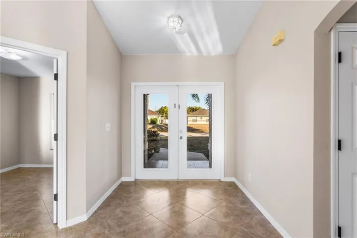 Entryway with french doors and tile patterned floors