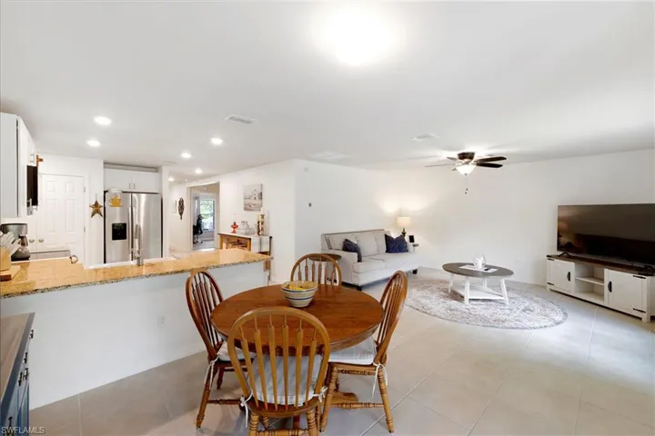 Dining space with recessed lighting, light tile patterned floors, and a ceiling fan