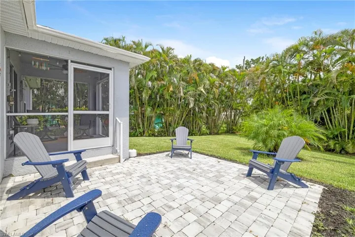 View of patio with a sunroom