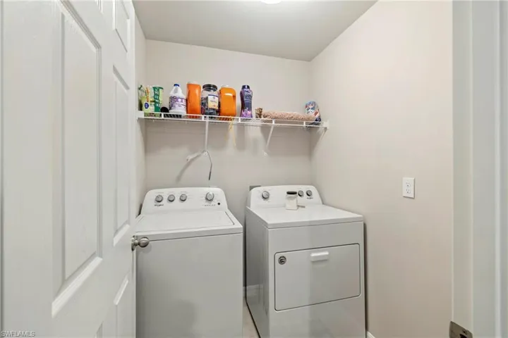 Laundry area with washer and dryer and baseboards
