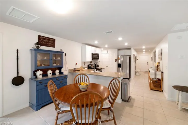 Dining space featuring light tile patterned floors and recessed lighting