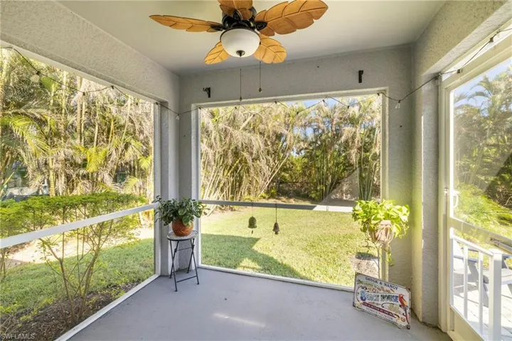 Unfurnished sunroom with a ceiling fan and healthy amount of natural light