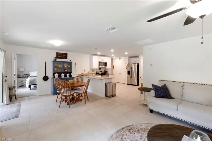 Dining space with ceiling fan and light tile patterned floors