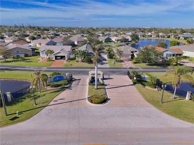 Aerial perspective of suburban area featuring a large body of water