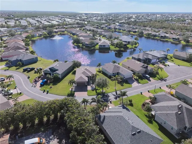 Aerial overview of property's location with a large body of water and nearby suburban area