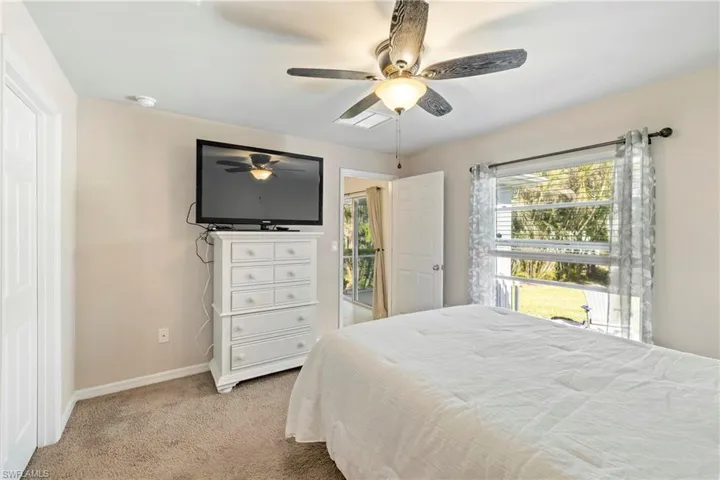 Bedroom featuring light carpet and ceiling fan
