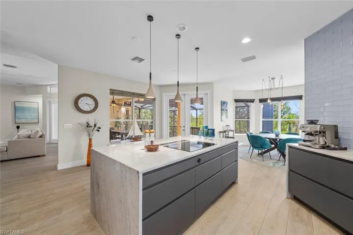 Expansive kitchen island with a light-toned countertop and integrated cooktop