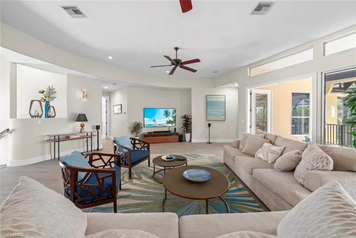 Open-concept living space featuring wood-finish flooring, recessed lighting, and a ceiling fan