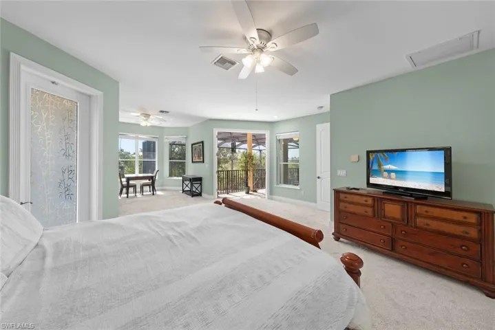 Spacious room featuring light green walls and light-toned carpet flooring