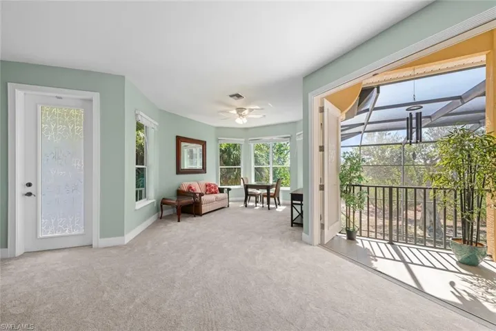 Expansive room featuring light green walls and plush carpeting